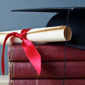 Graduation cap, diploma, and books
